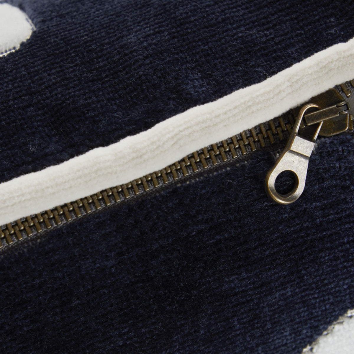 A dark blue Genoa velvet zippered pouch with white trim.