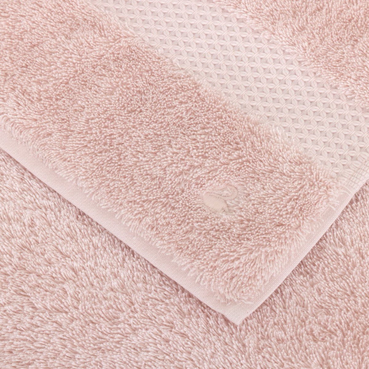 Fabric Closeup of Folded Yves Delorme Etoile Bath Towels in Petale