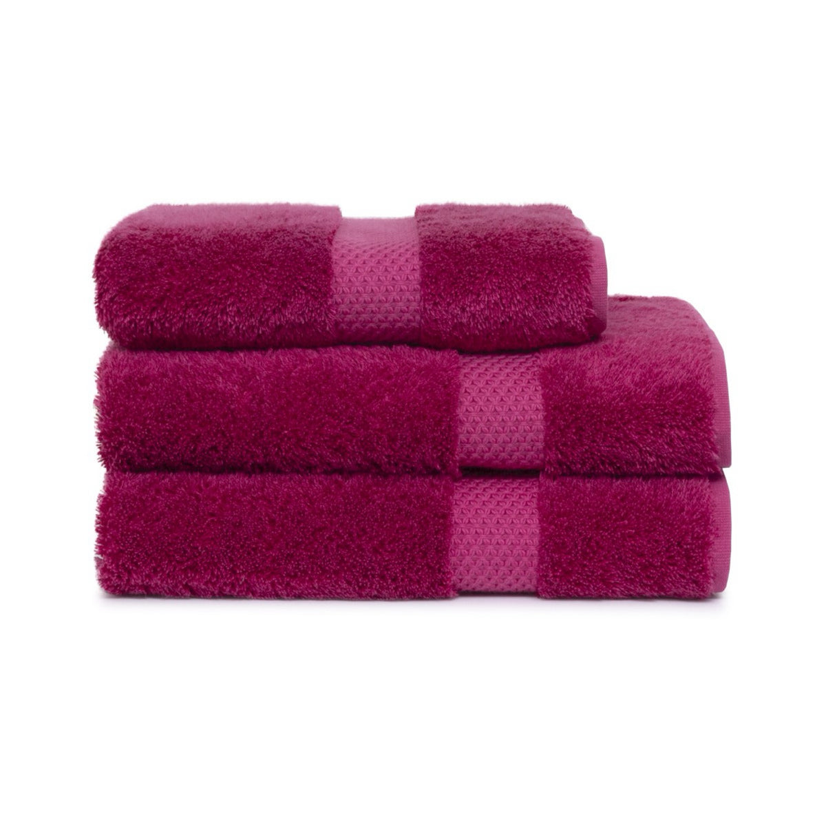 Three folded Etoile Bath Towels stacked on top of each other against a white background.