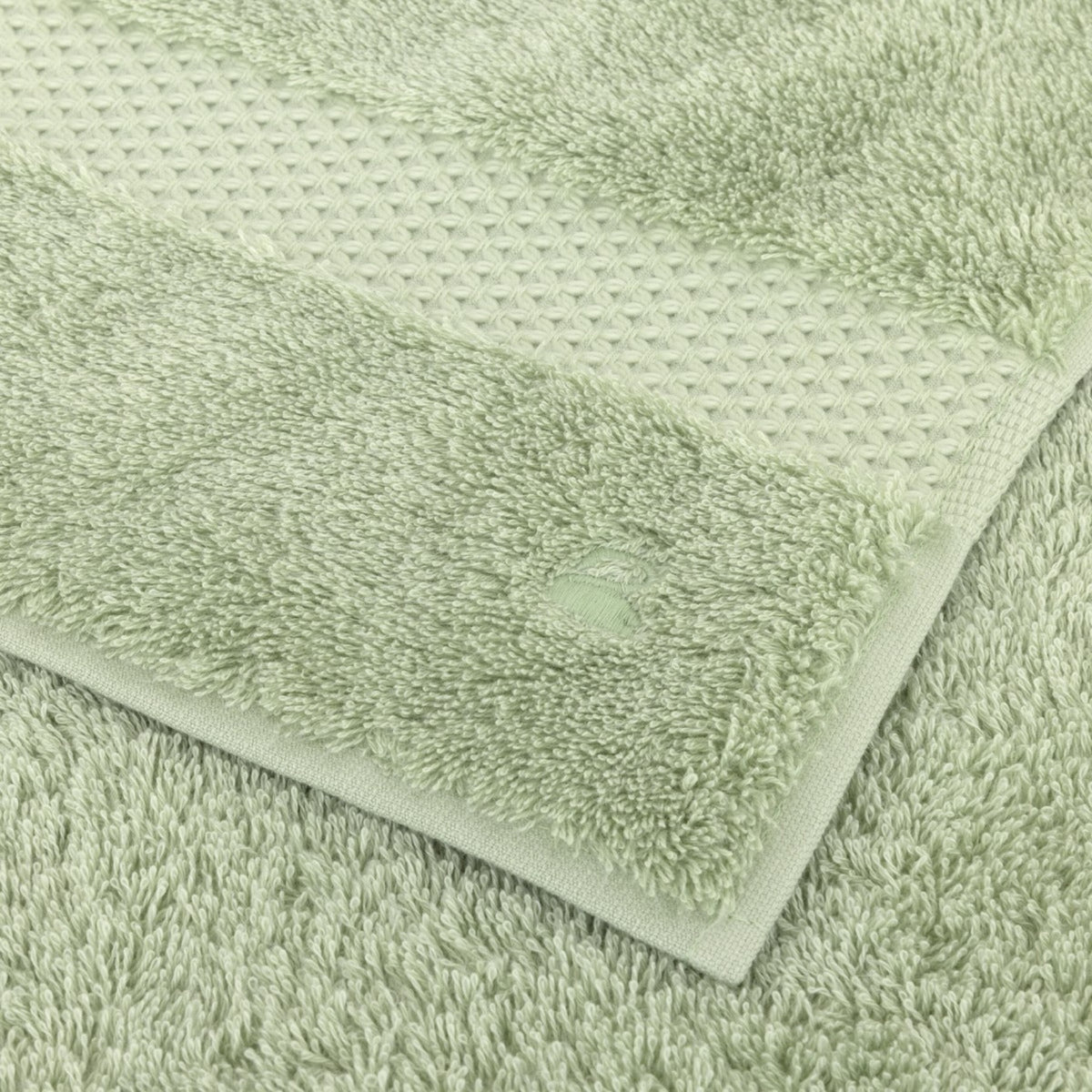 Fabric Closeup of Folded Yves Delorme Etoile Bath Towels in Amande