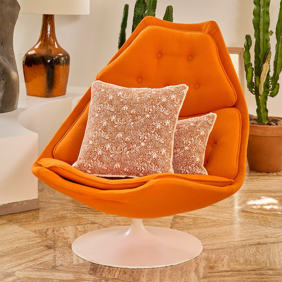Decorative Pillows of Yves Delorme Eze Bedding Collection on a modern Orange chair