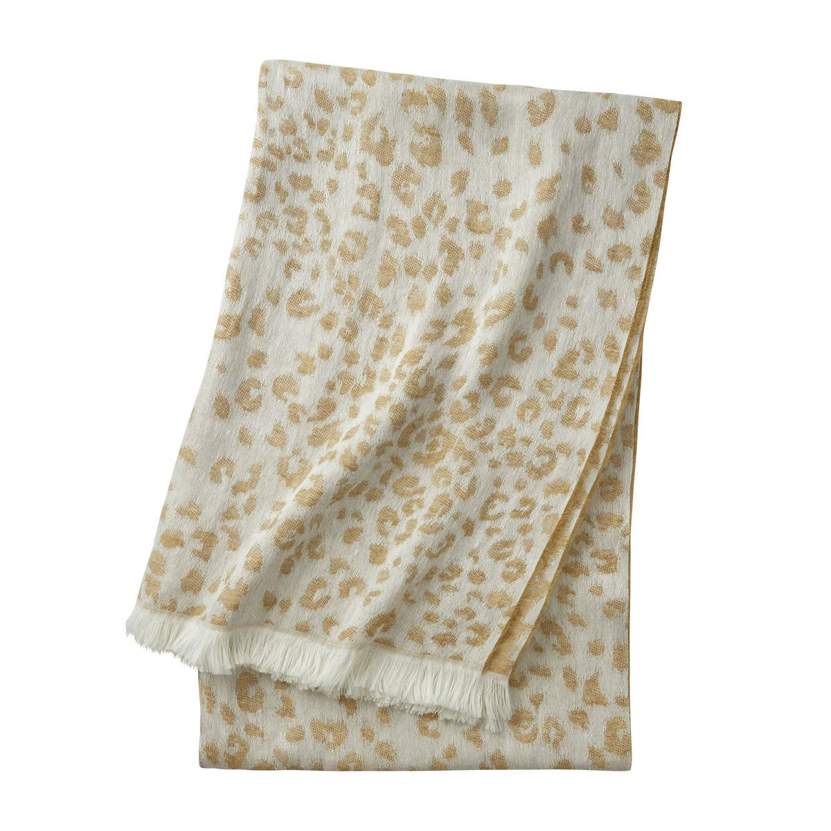A Yves Delorme Fauve Throw in Mordore color, white fringe, folded on a white background