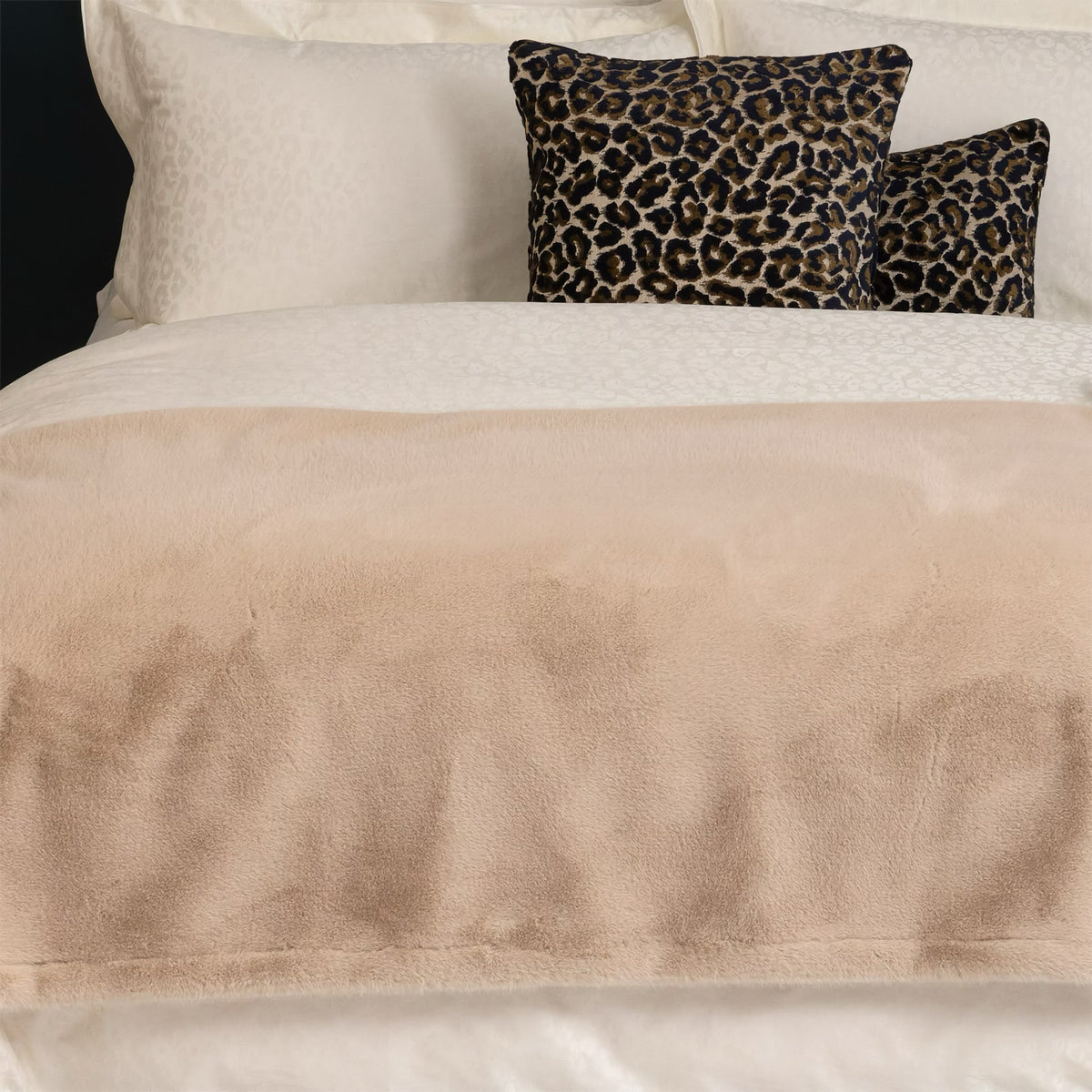 Yves Delorme Frisson Throw in Noisette color on a bed