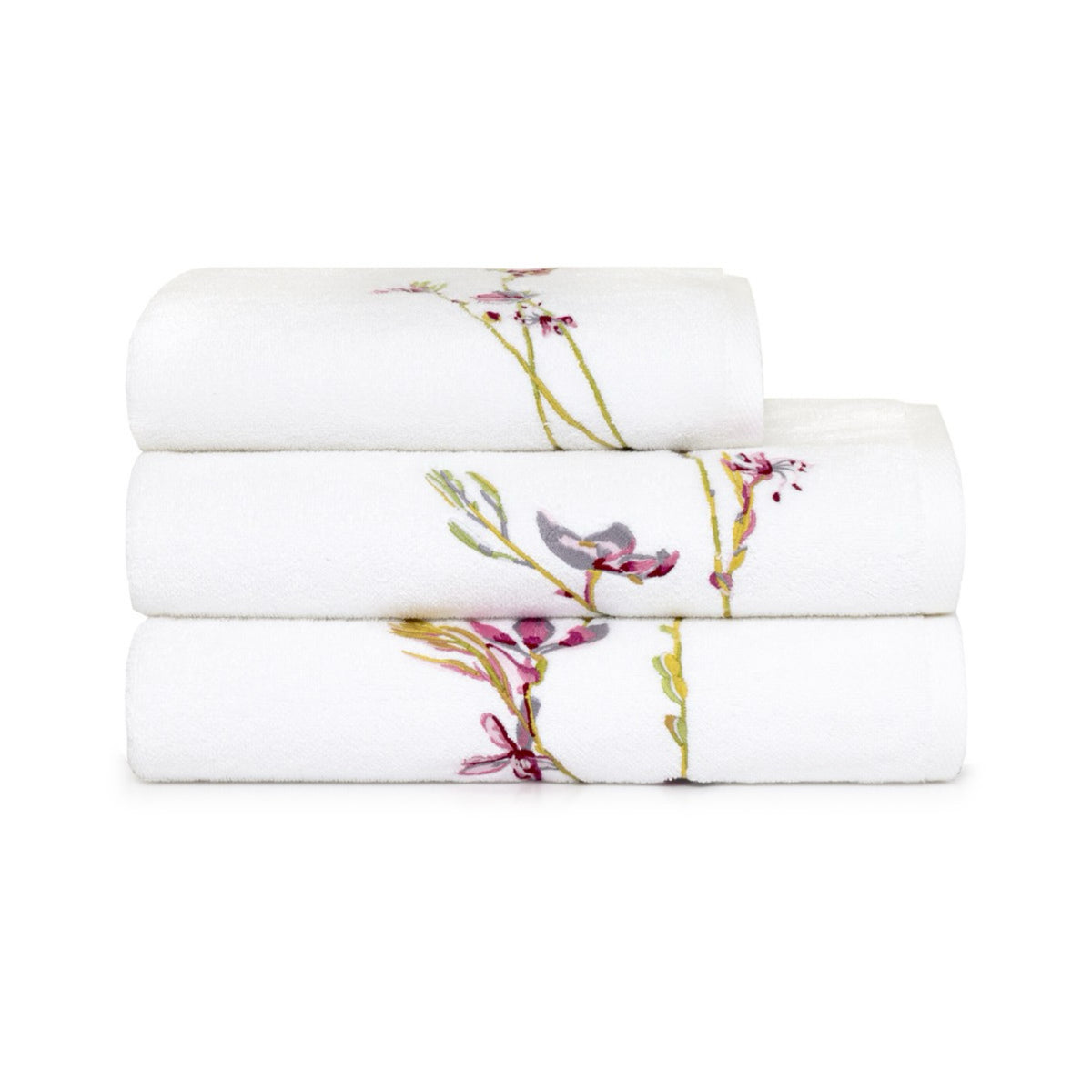 Three Yves Delorme Gaura Bath towels stacked, each with a floral embroidery design