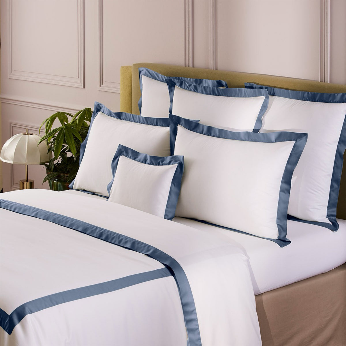 Corner view of bed with Yves Delorme Linéa cotton sateen bedding in Outremer color