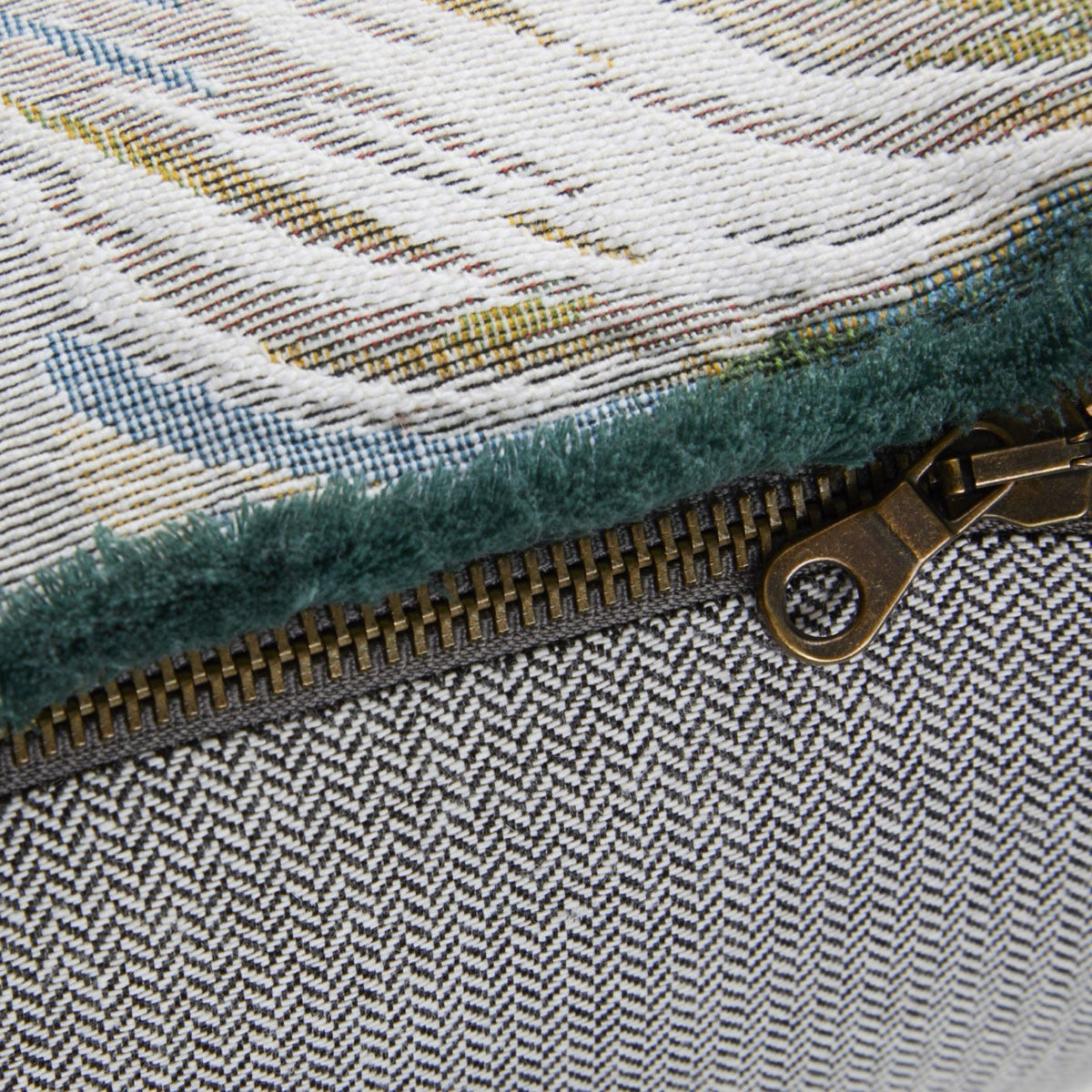 Closeup of Paon Yves Delorme Manaca Decorative Pillow highlighting its metal zipper