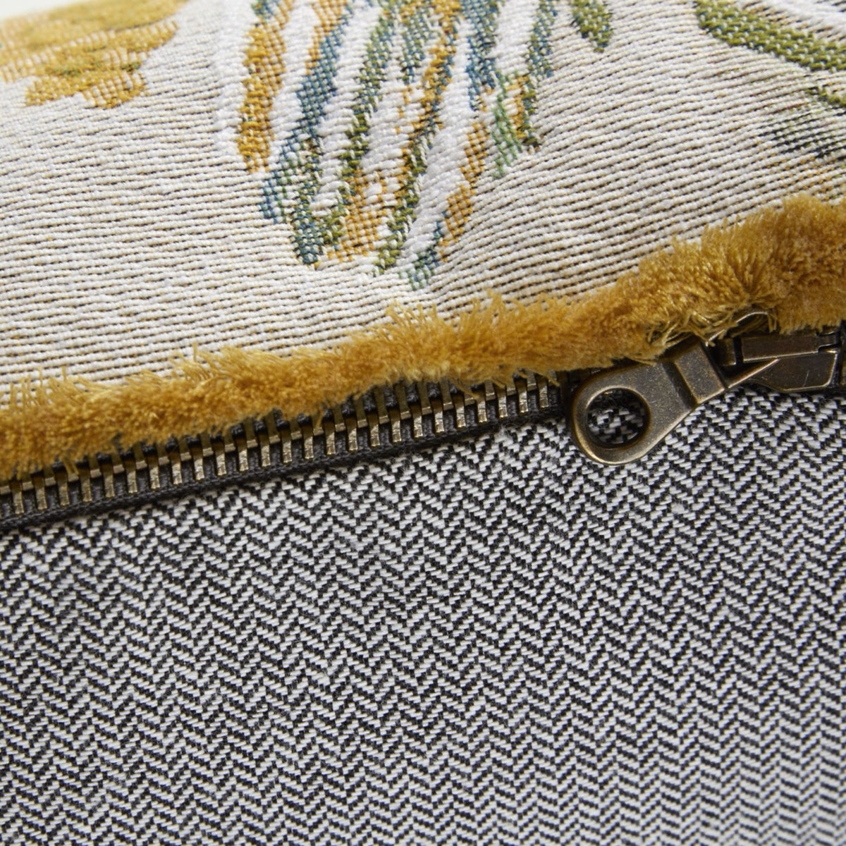 Closeup of Rosee Yves Delorme Manaca Decorative Pillow highlighting its metal zipper