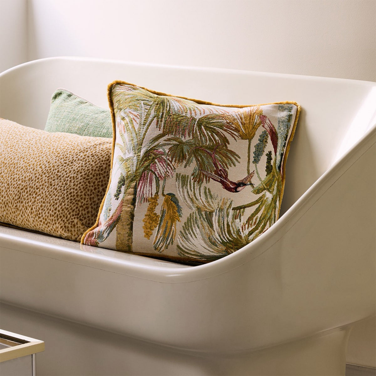 Rosee Yves Delorme Manaca Decorative Pillow on a bench with other decorative pillows