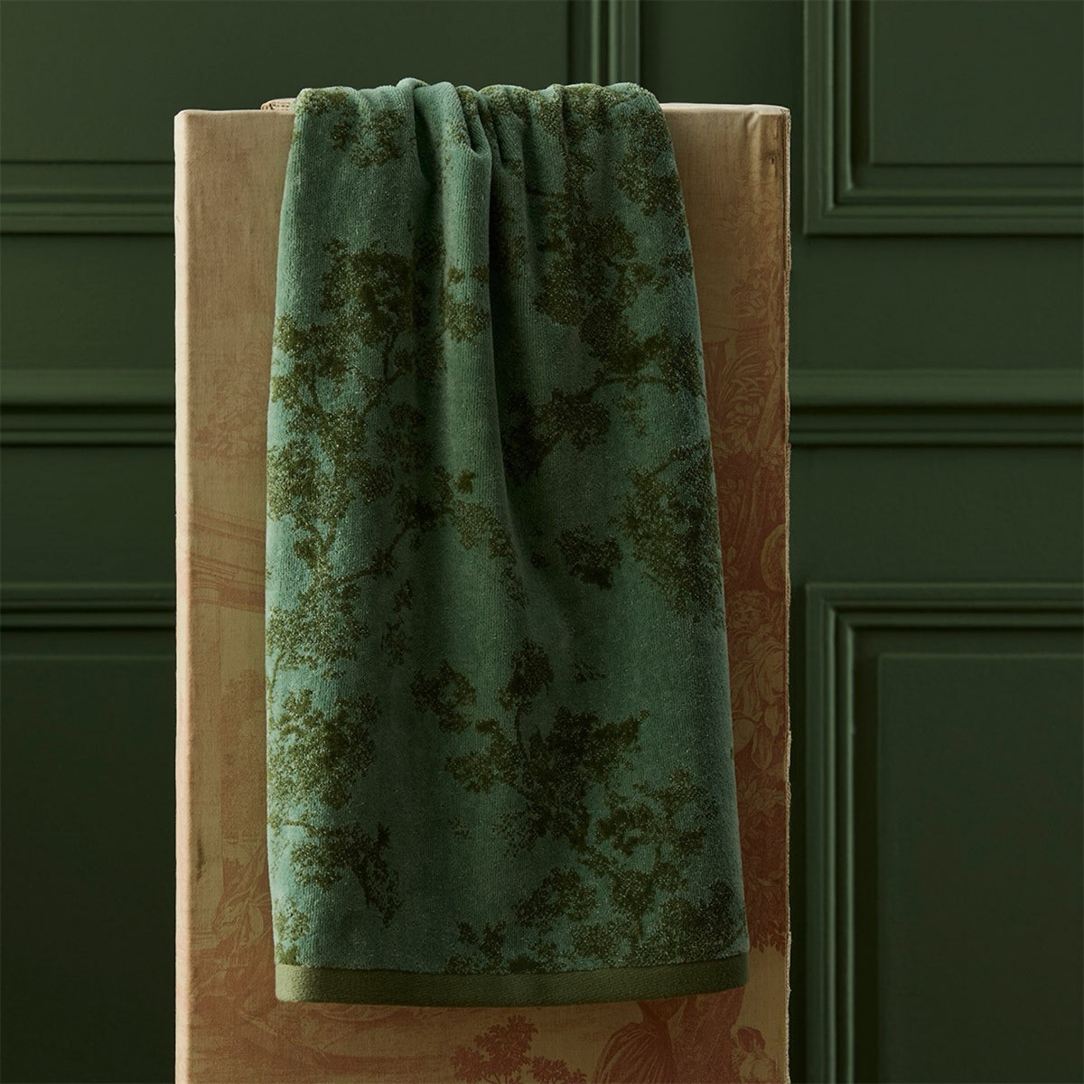 Yves Delorme Muses Bath Towel against a green wall