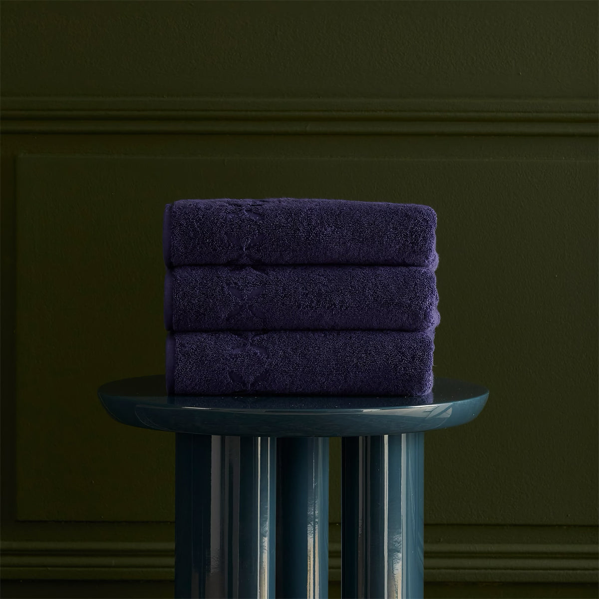 Stack of Yves Delorme Nature Bath Towels in Encre color