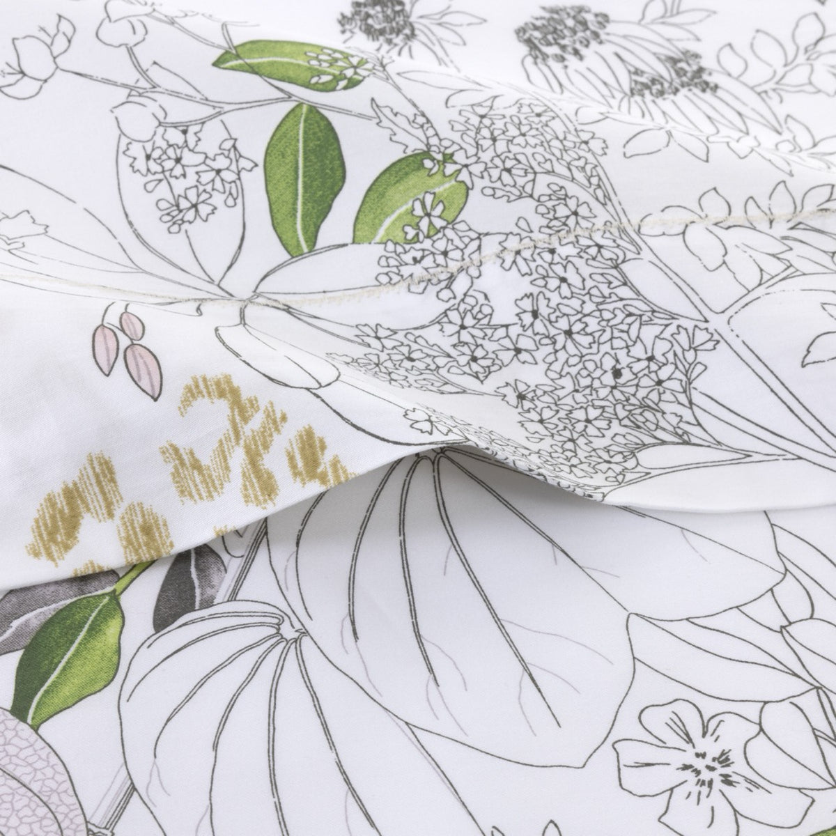 Close-up of white cotton satin bedding from the Yves Delorme Orchidée Collection
