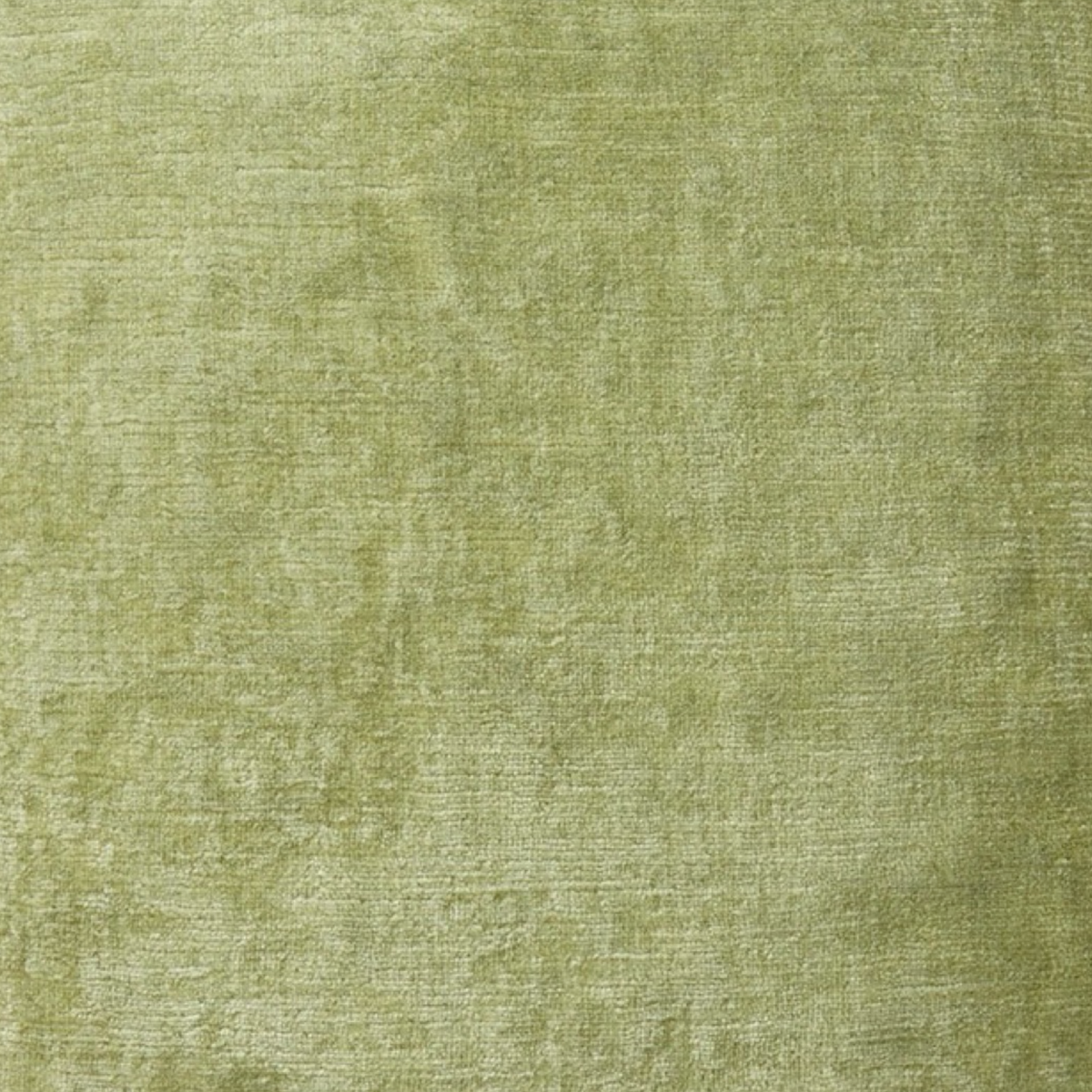 Light green textured Yves Delorme Orphéo velvet decorative pillow.