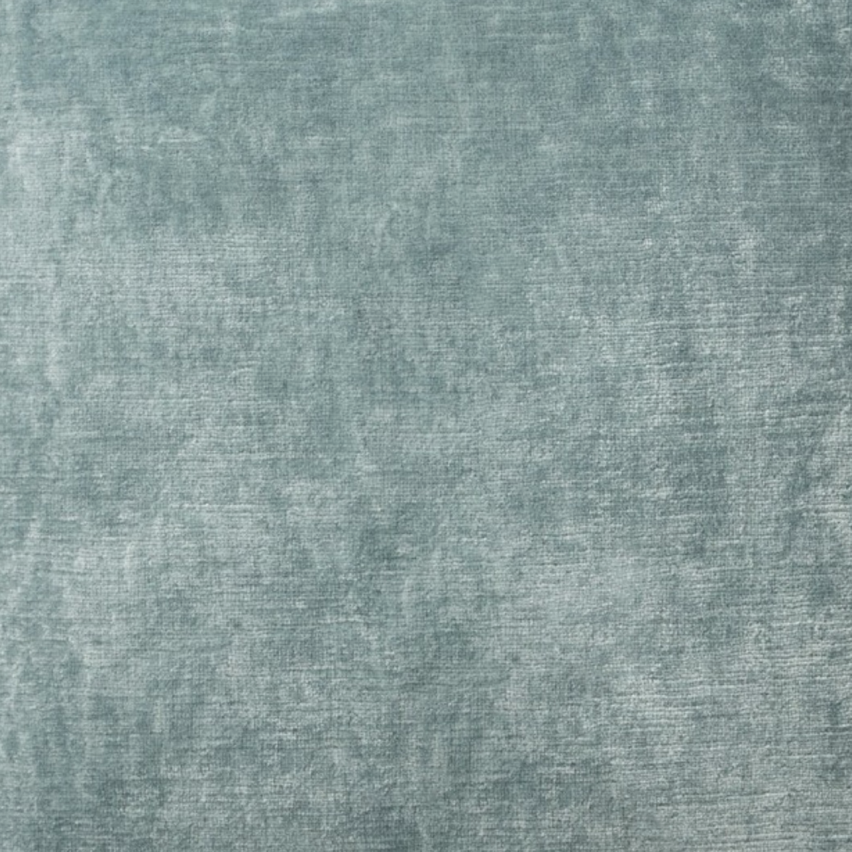 A close-up view of textured teal Italian velvet.