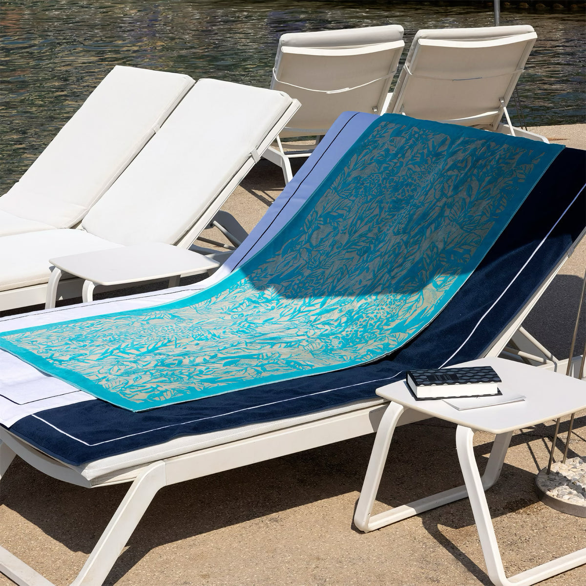 Bench with Yves Delorme Sao Beach Towels in Lagon