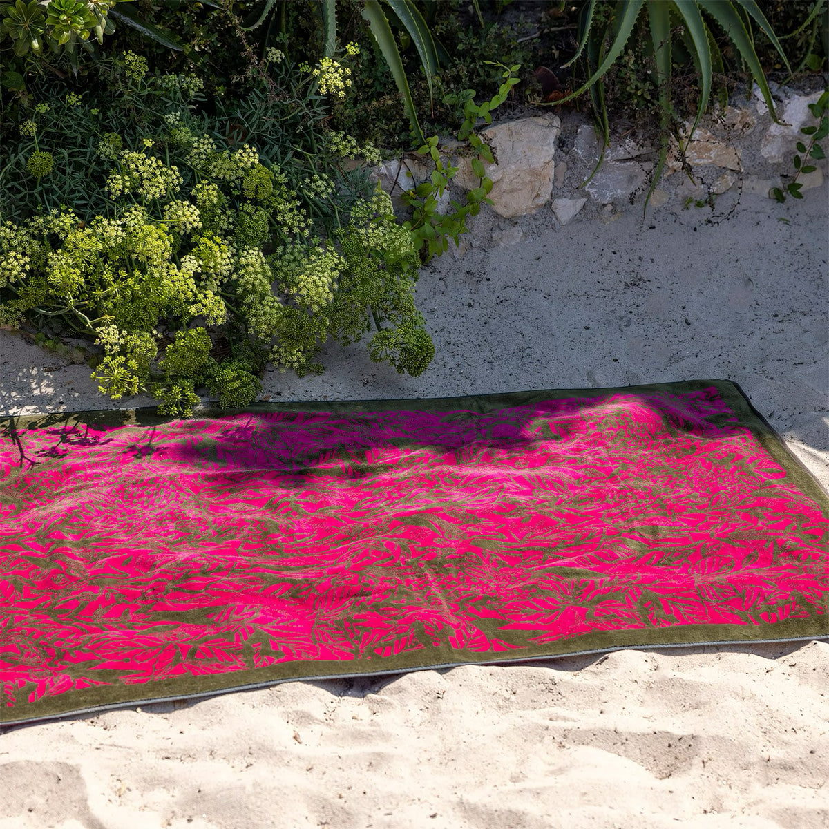 Yves Delorme Sao Beach Towels in Fuchsia on ground