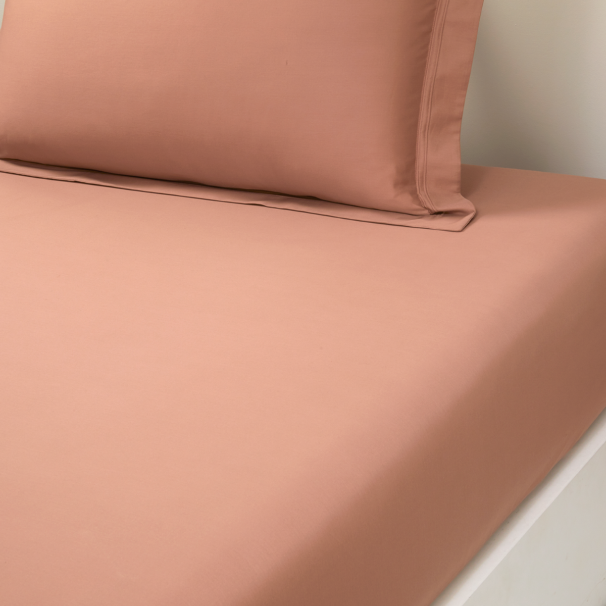 Closeup of Fitted Sheet of Yves Delorme Triomphe Bedding in Sienna Color