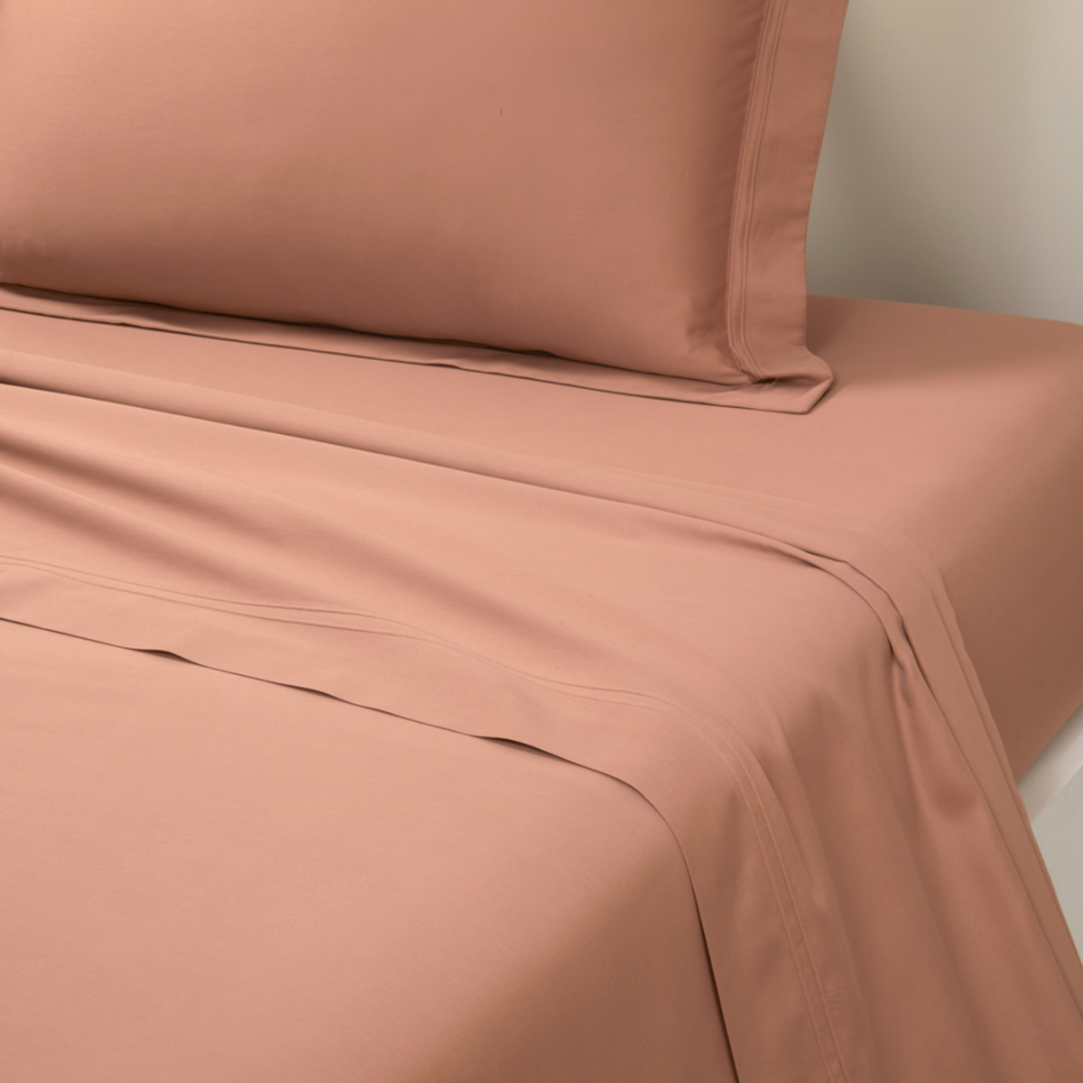 Closeup of Flat Sheet Yves Delorme Triomphe Bedding in Sienna Color
