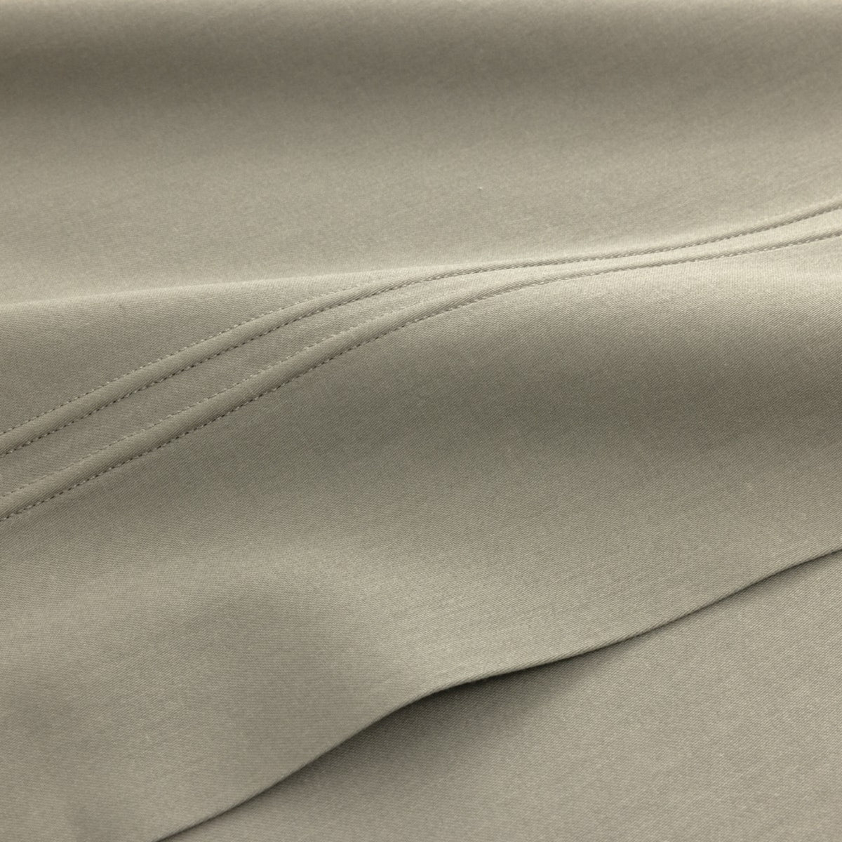 Close-up of luxury organic cotton bedding from Yves Delorme Triomphe in Kaki