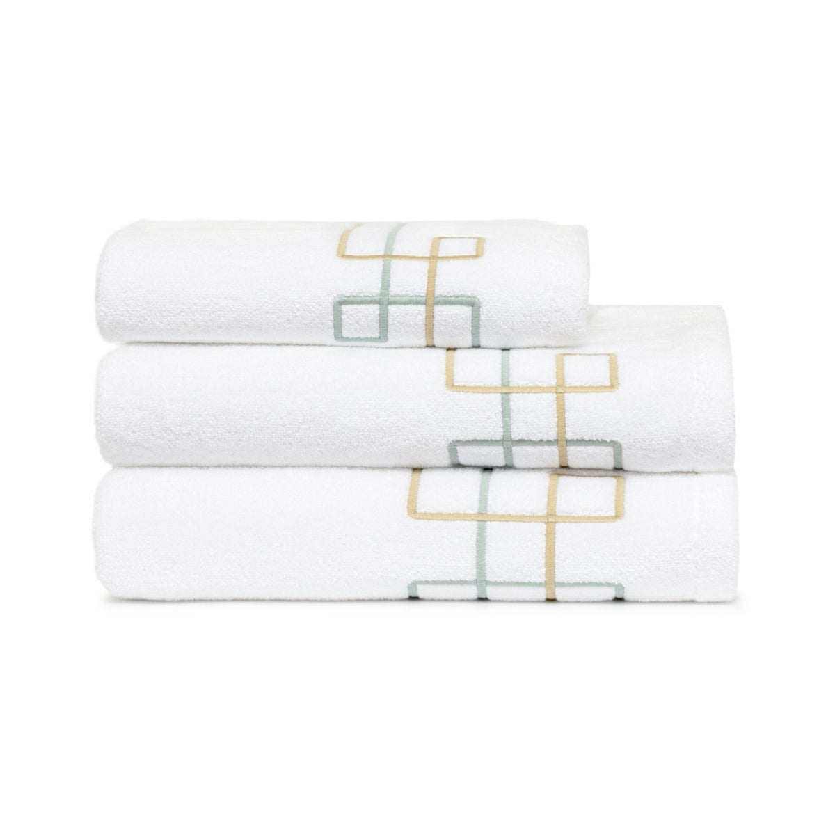 Three folded Yves Delorme Villa Bath Towels, stacked neatly against a white background.