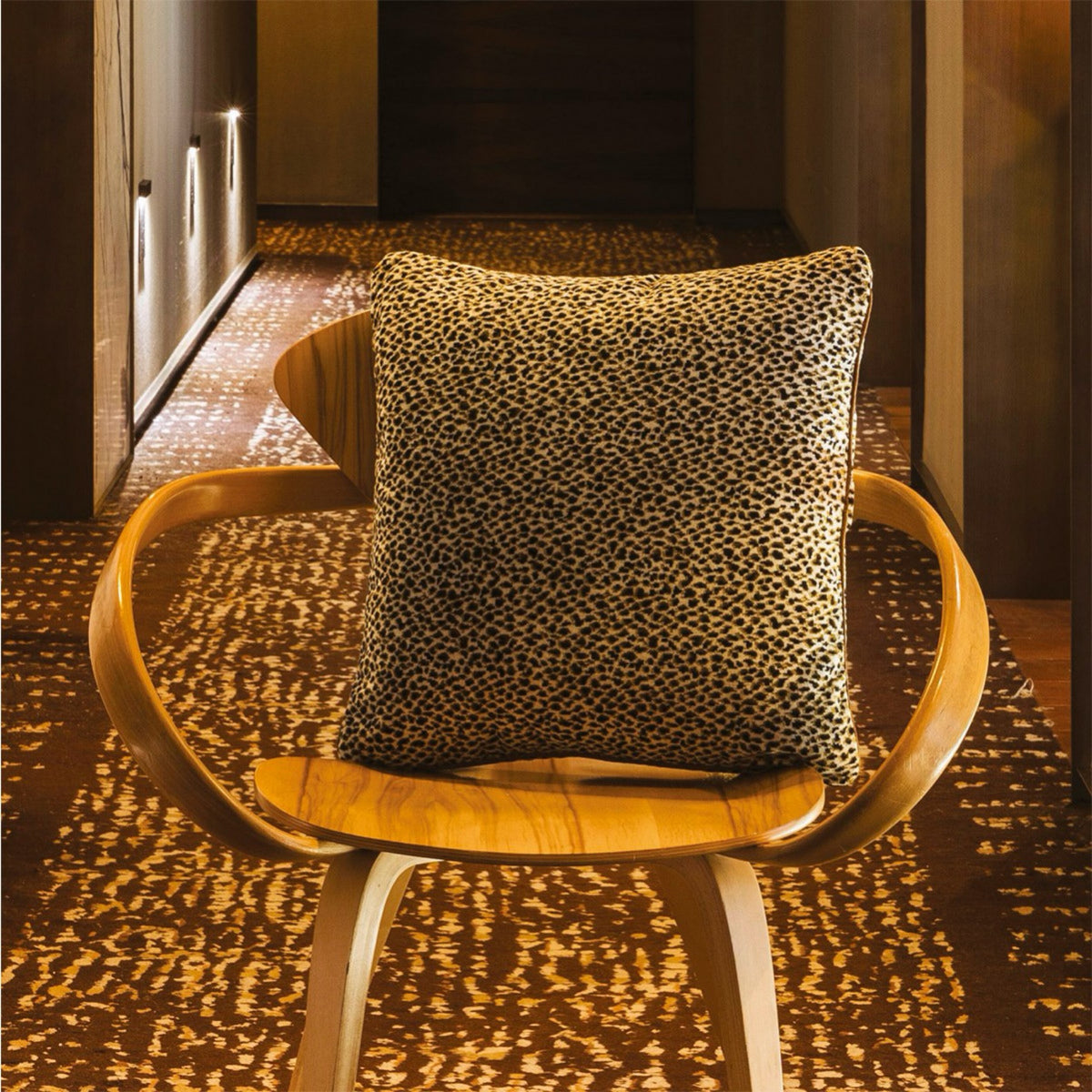 Nuit Yves Delorme Zenaide Decorative Pillows on a modern chair