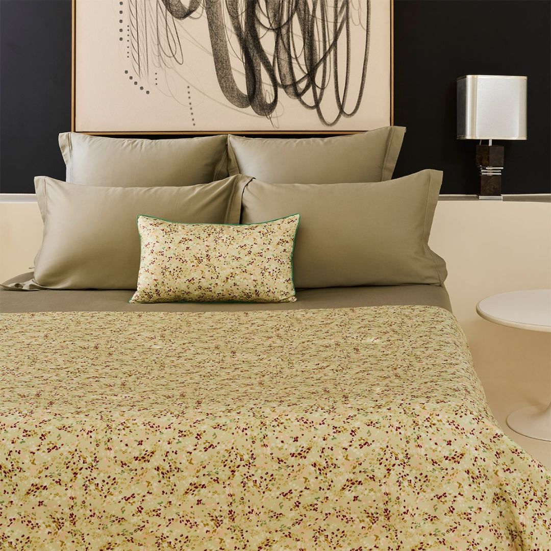 Yves Delorme green patterned counterpane and dec pillow on bed with green bedding