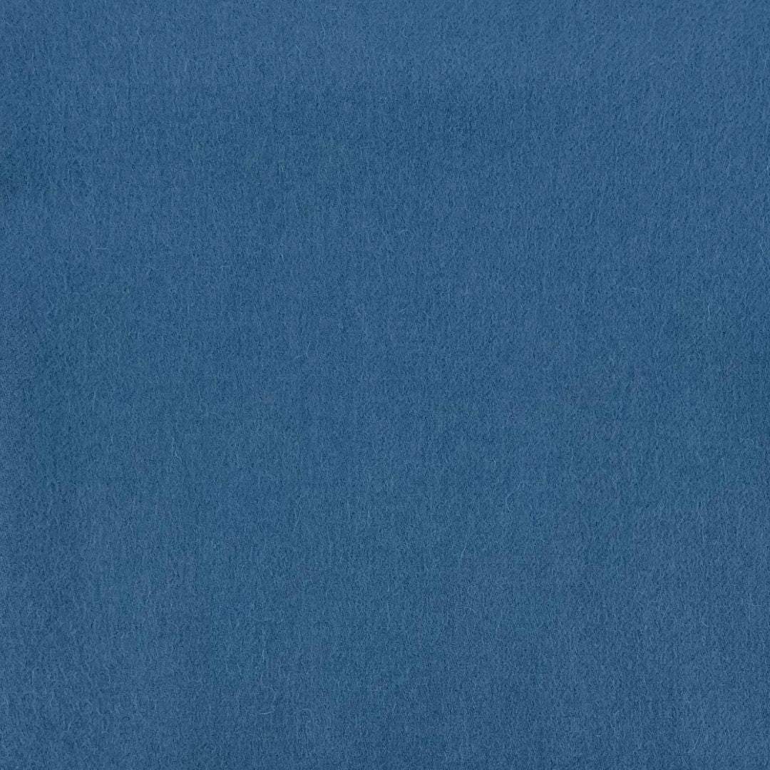 A flat, uniform surface of blue fabric with a soft, fuzzy texture like an Alashan throw and no visible patterns or markings.