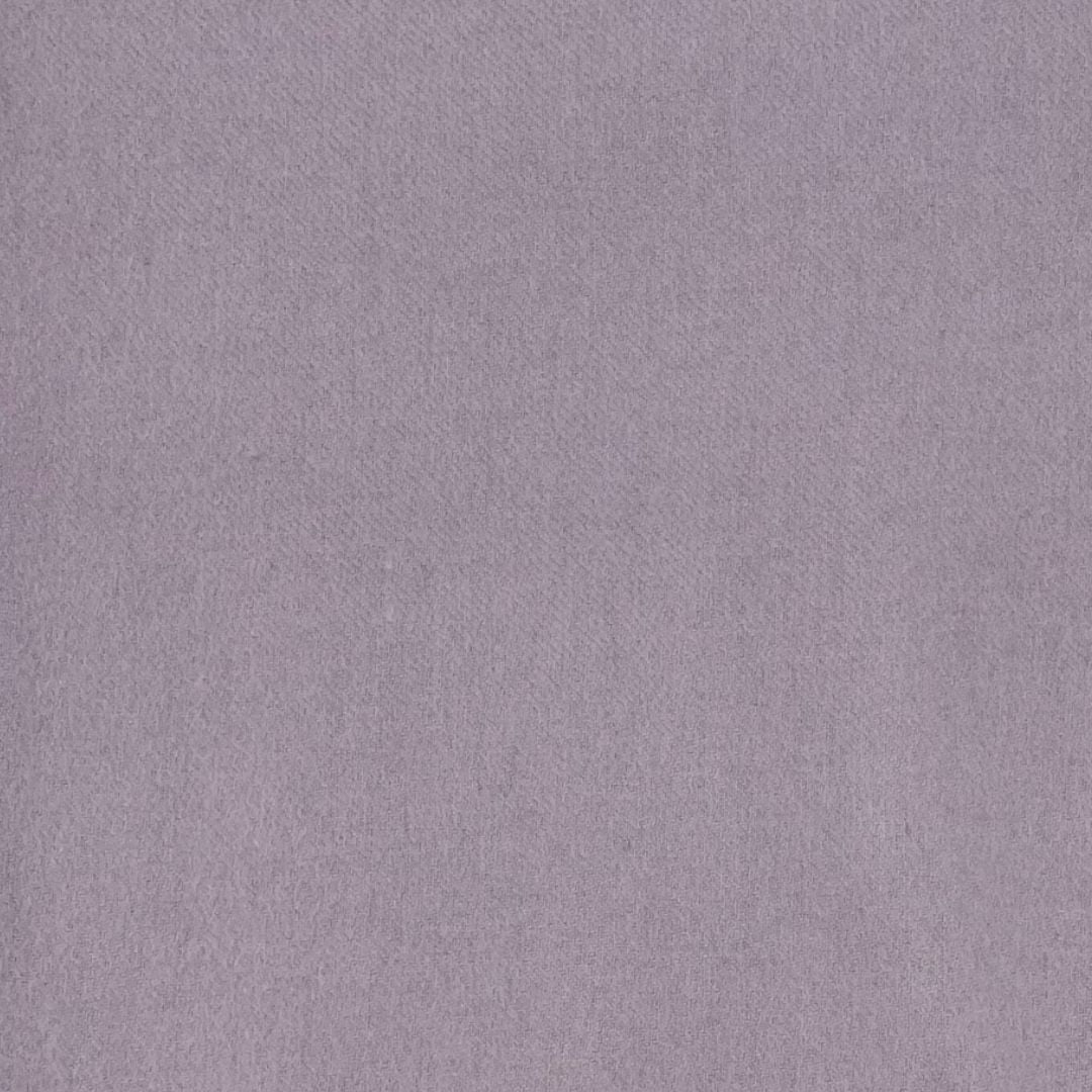 A close-up view of a plain, textured lavender fabric surface, ideal for woven blankets or plain weave throws.