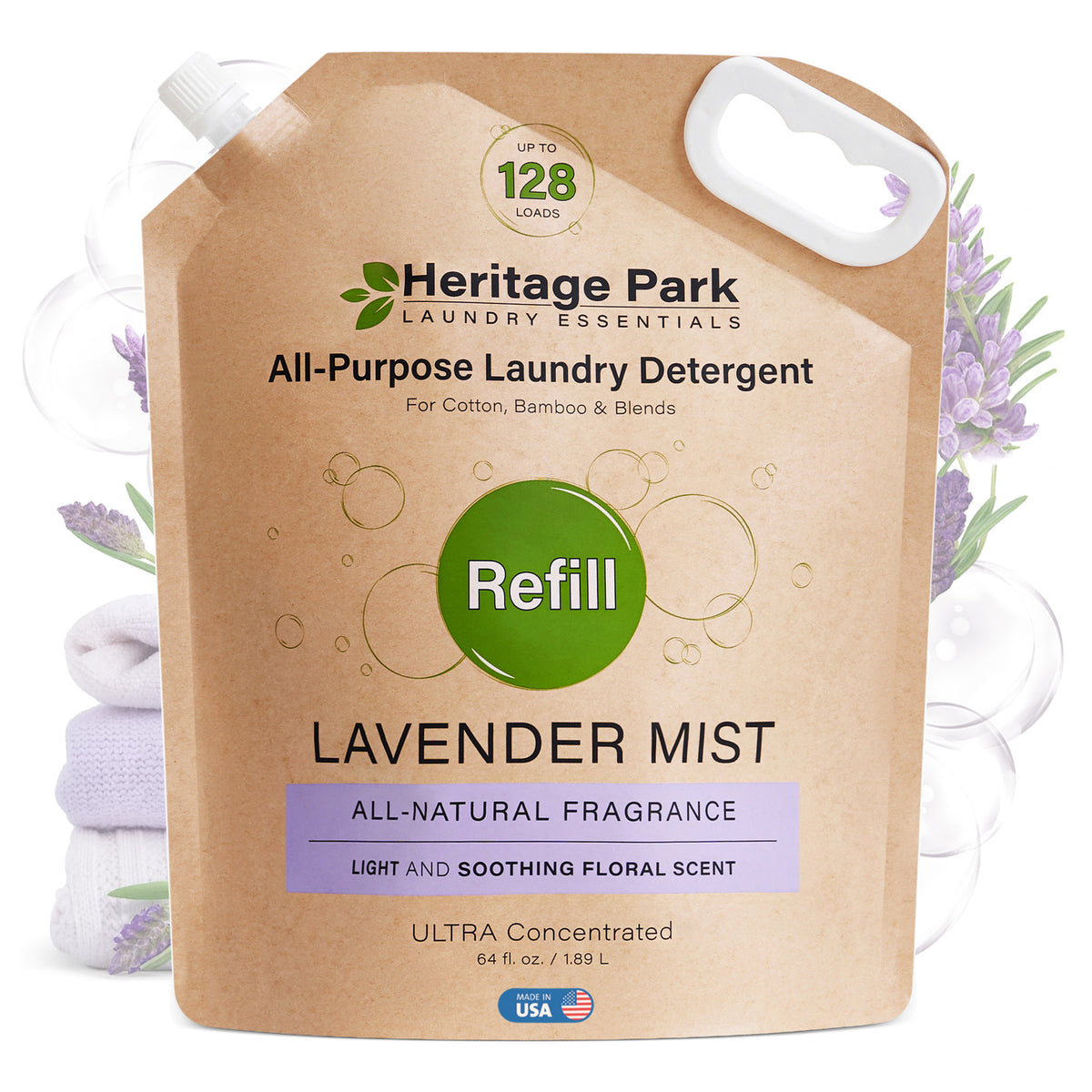 A pouch of Heritage Park luxury laundry detergent with a refill label and folded towels in the background.