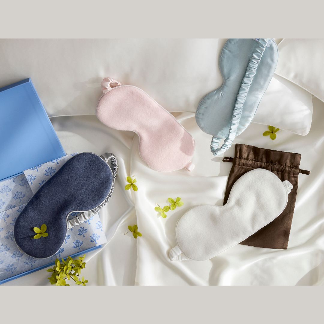Set of eye masks in various colors on a white fabric background