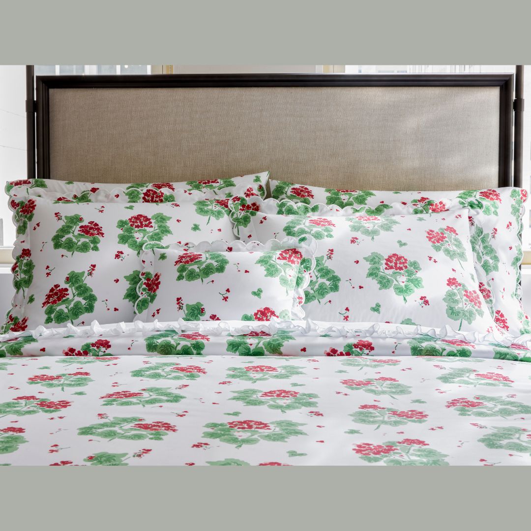 Floral patterned bedding set on a bed with a neutral headboard.
