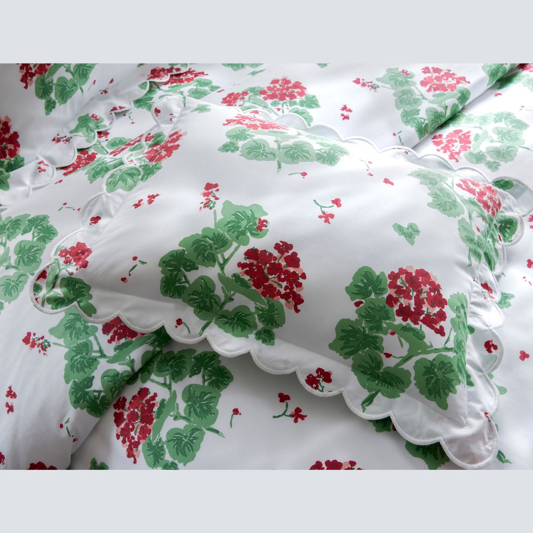 Floral-patterned fabric with red and green flowers on a white background