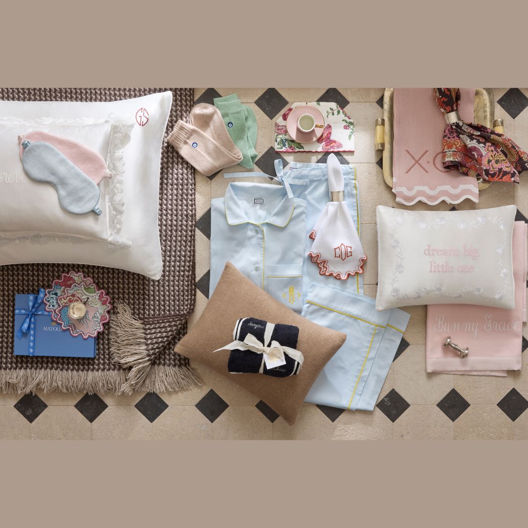 Collection of gift items including pillows, socks, and blankets on a checkered surface.