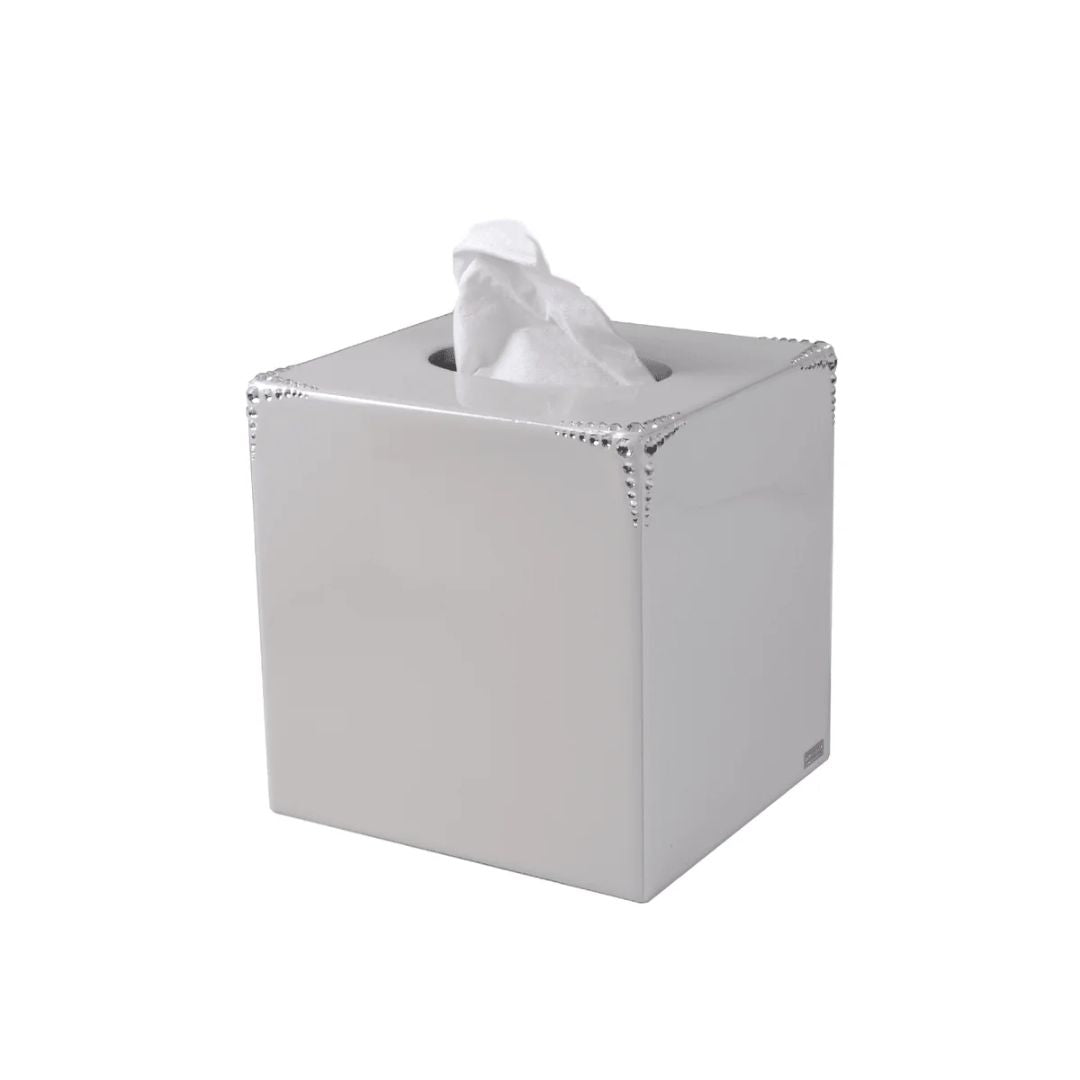 Silver embellished tissue box with tissues on a white background