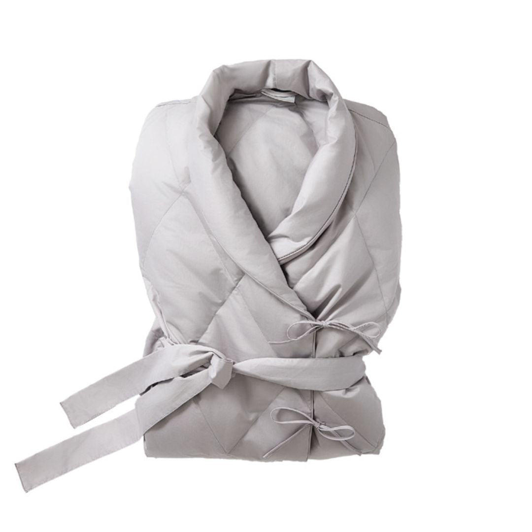 A light gray, quilted cotton sateen robe with a shawl collar and fabric waist tie, neatly folded by Scandia Home.