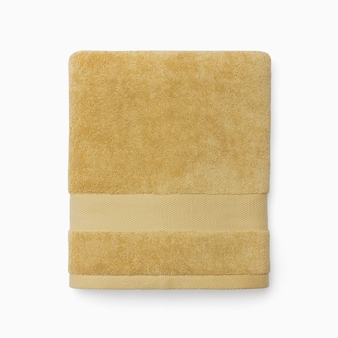 A folded Sferra Bello Nuovo Towel with a textured band, crafted from long-staple combed cotton, on a white background.