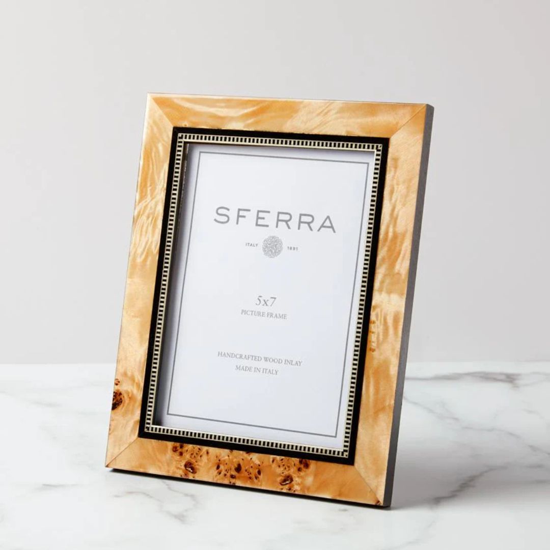 A rectangular, gold-toned Sferra Catania Photo Frame sits on a white marble surface with an insert labeled Sferra.