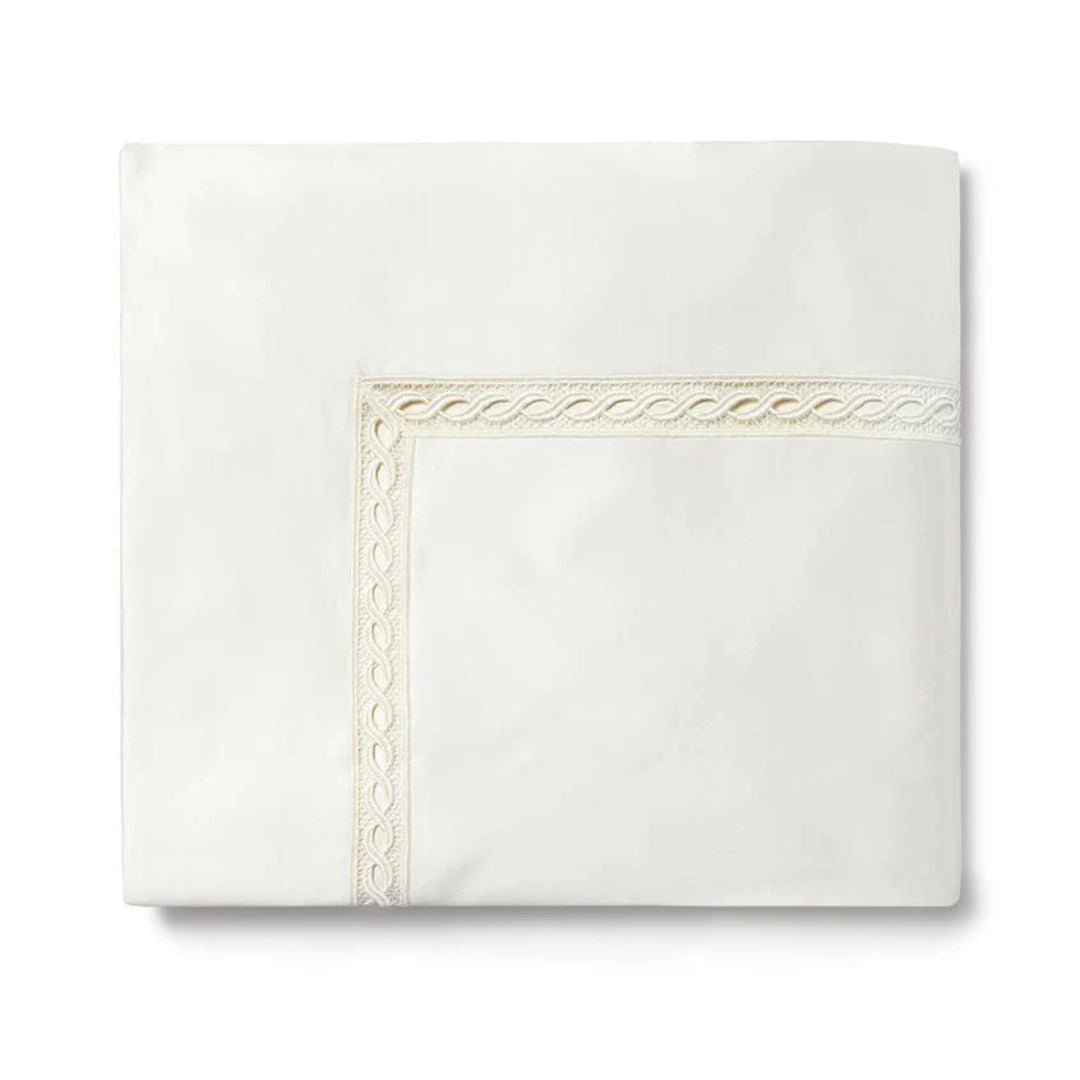 Folded luxury Egyptian cotton sheet with a decorative embroidered border, displayed on a plain white background.