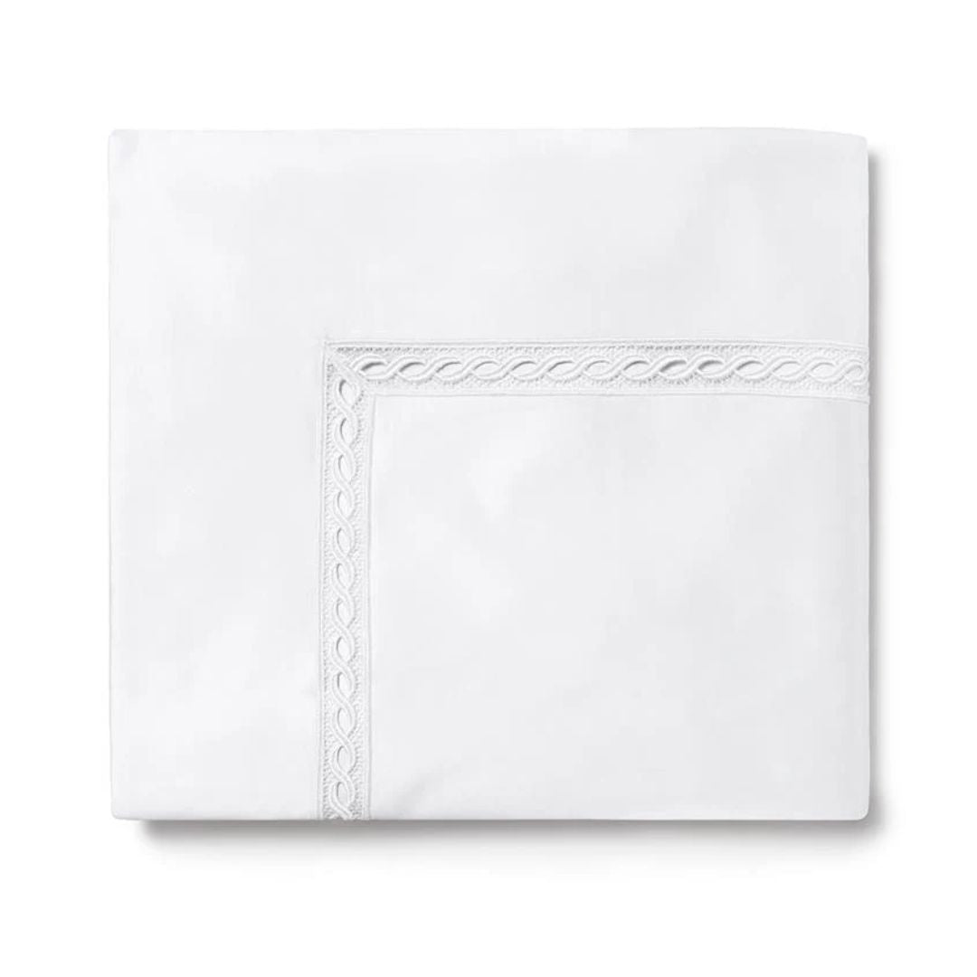 Folded Sferra Millesimo bedding with decorative lace trim, crafted from luxury Egyptian cotton sheets.
