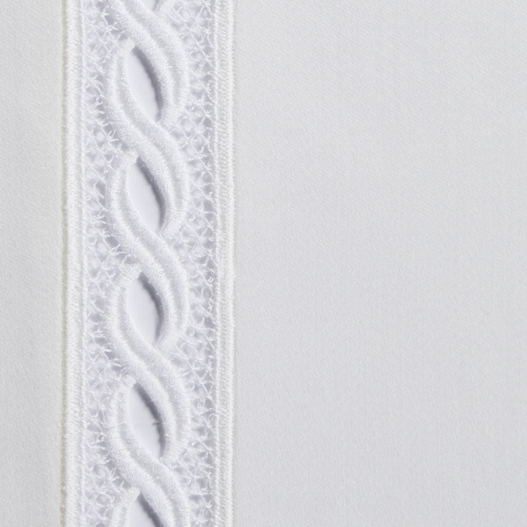 Close-up of Sferra Millesimo luxury Egyptian cotton sheets with a raised, braided trim running vertically on the left.