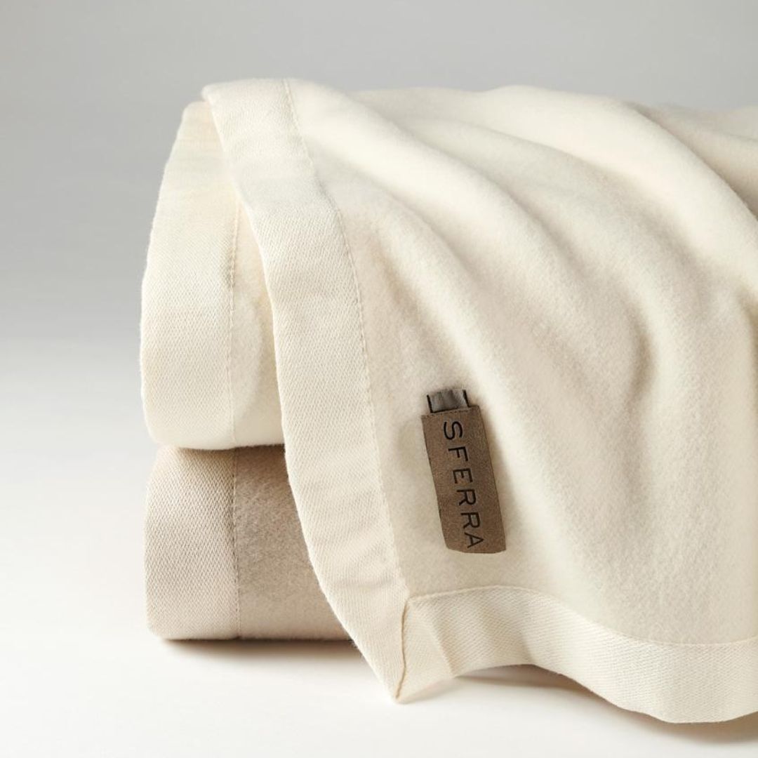 A folded Ultra-Fine Merino Wool Blanket with a visible SFERRA label on a neutral background.