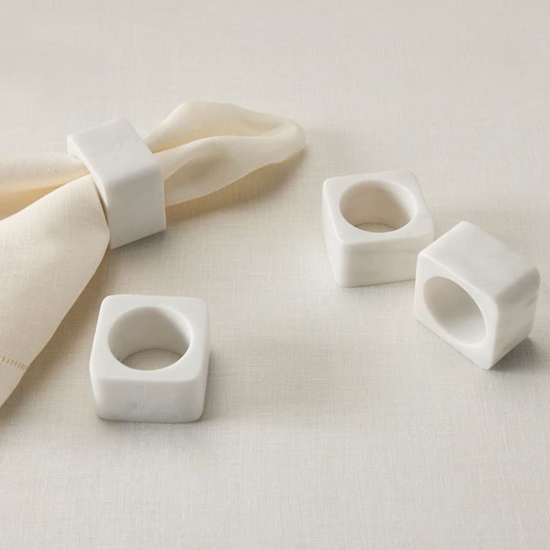 Set of white ceramic rings on a light fabric background