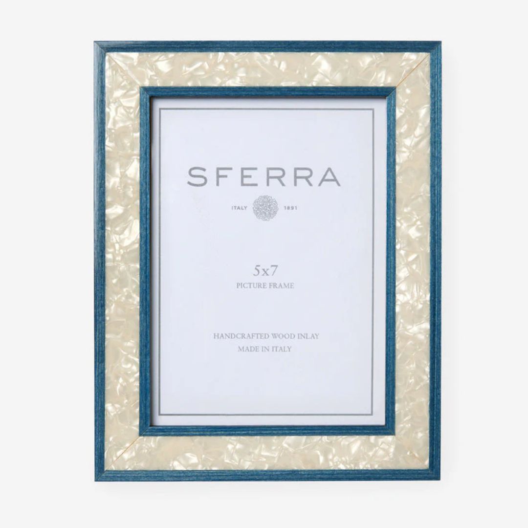 A handcrafted Italian photo frame with a blue and pearl inlay border, standing upright with product branding displayed inside.