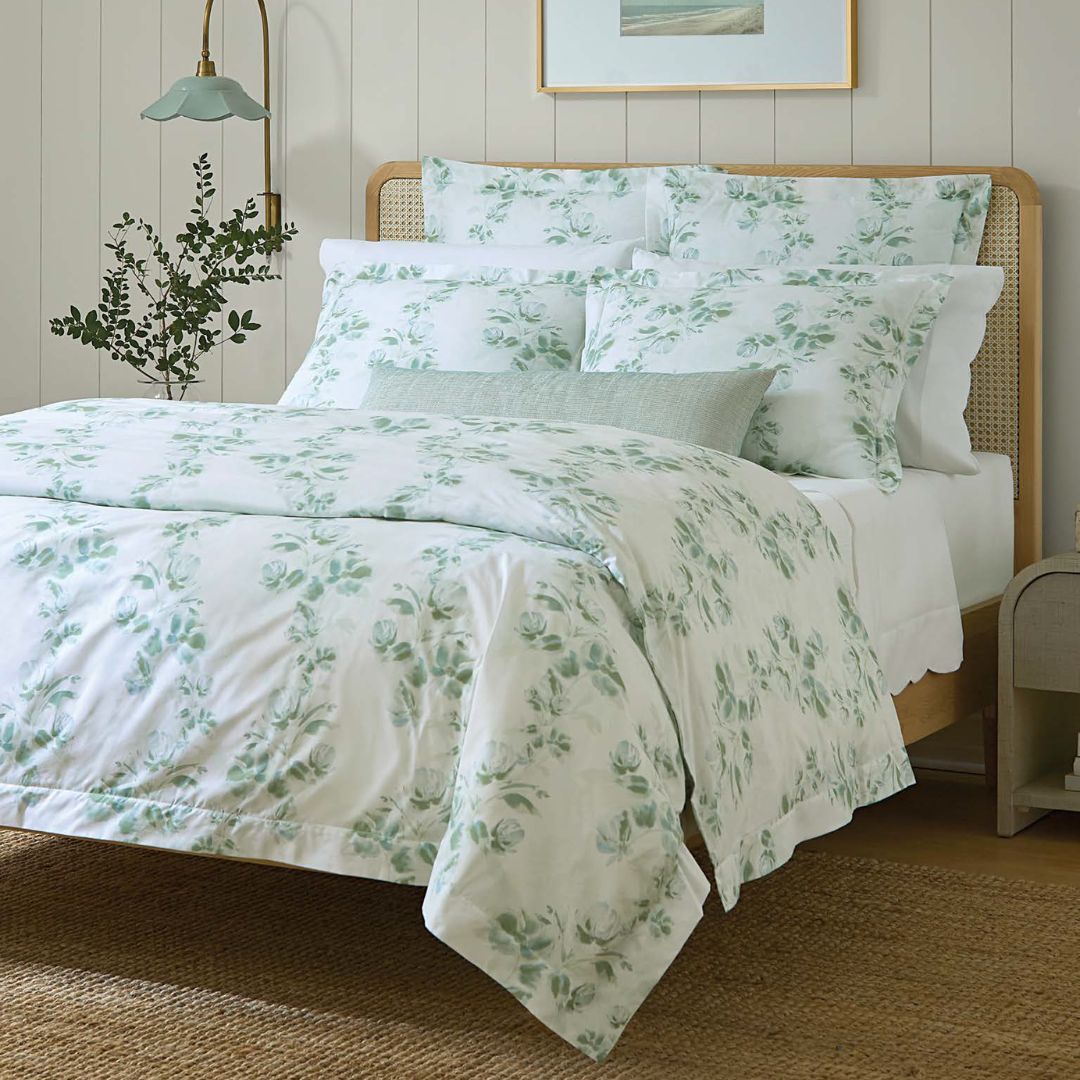Bedroom with floral bedding and a wooden headboard