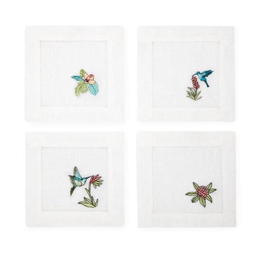 Set of four embroidered coasters with hummingbird and floral designs on a white background.