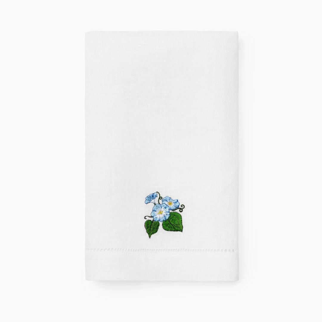 White guest towel with embroidered blue flowers on a white background