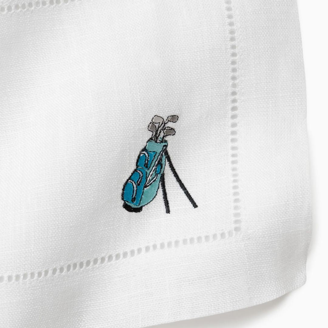 Embroidered design of a golf bag with clubs on a white cocktail napkin