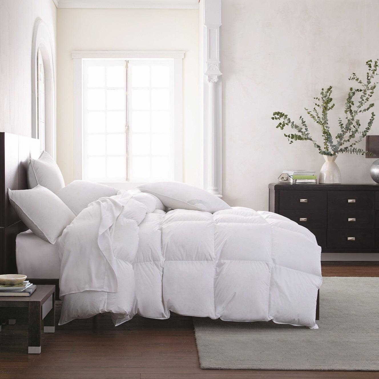 Scandia Home Vienna Comforter and Pillows on a bed with modern furniture