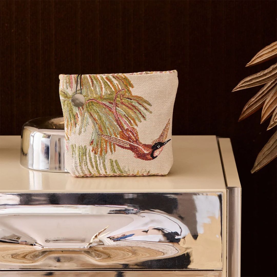Small cotton jacquard tapestry pouch featuring a woven hummingbird and tropical floral motif on a metallic surface.