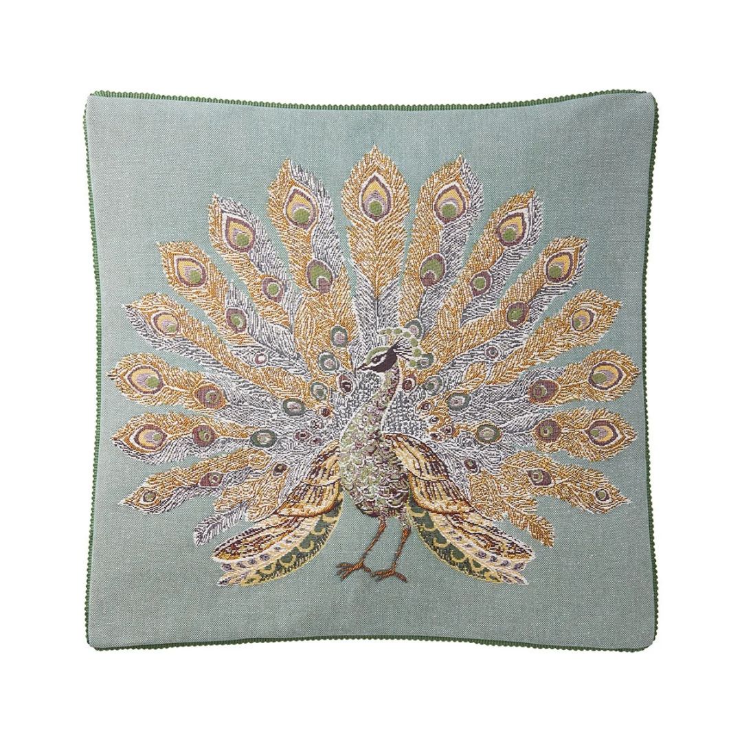 Square light blue Yves Delorme decorative pillow featuring a peacock with an elaborate, fanned-out peacock jacquard tapestry.