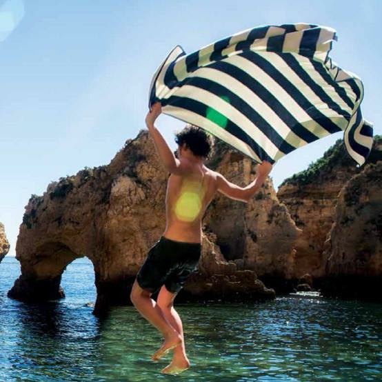 Abyss Prado Beach Towels Lifestyle Model Jump Fine Linens